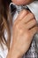 Female hand holding a gray tie. studio