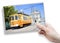 A female hand holding an postcard about the historical trasportation of Porto - on background the `Igreja do Carmo e Carmelitas` c