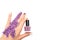 Female hand holding purple nail polish bottle. Spring concept