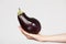 Female hand holding a ripe aubergine