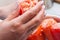 Female hand holding Ripe red vegetable bell stuffed pepper.