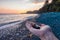 Female Hand holding rocks and pebble at Sandcut Beach on the West Coast