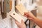 Female hand holding the sample color plate of wood door for  set up in house