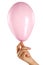 Female hand holding a small pink baloon