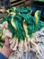 Female hand holding a stack of rubberized gloves for gardening in hardware store