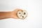 Female hand holding a three ripe sweetsop custard apple on a white background.