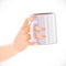 Female hand holding white ceramic drink cup