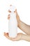 Female hand holding white plastic container bottle