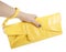 Female hand holding yellow clutch bag