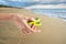 Female hand holding yellow fidget spinner on blurred background