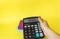 Female hand holds calculator with text on display PAYROLL