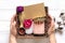 Female hand holds care box Set of eco - friendly cosmetics Bath salt, wooden comb, pumice stone, aroma candles, handmade soap,