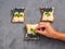 Female hand holds lays a wash sheet on a homemade sandwich with cottage cheese, blueberries, banana, on a dark background