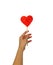 A female hand holds a lollipop on a heart shaped stick