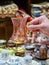 Female hand holds a souvenir Turkish tea glass with a spoon