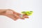 Female hand with Jungle Mist colored nails holding yellow fidget