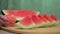 Female hand keeping a freshly peeled bowl of watermelon - tropical fruit