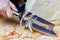 Female hand with knife for shredding cabbage and head of fresh white cabbage on the wooden cutting board