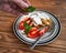 A female hand lays a sprig of mint on a pancake house