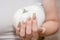 Female hand with long nail design. Glitter gold and white nail polish manicure. Female hand with perfect manicure hold pumpkin