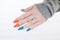 Female hand with long nails and multi-colored bottle manicure with nail polish