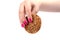 Female hand with a manicure holds oatmeal cookies with cereals over white background