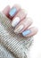 female hand manicure, stylish sweater winter creative