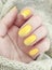 Female hand manicure winter closeup beauty yellow sweater decoration