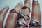 Female hand with many different rings blue color