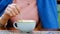 female hand mixes a teaspoon of cappuccino in a blue cup while sitting in a cafe. slow motion video