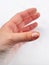 A female hand with nail peeling problem on the white background.