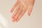 Female hand with natural manicure without gel polish on a white background with space for text. Hand energy