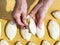 Female hand pinches a raw potato pie over pies