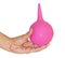 Female hand with a pink enema isolated