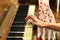 A female hand playing an old vintage piano.