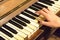 A female hand playing an old vintage piano.