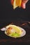 Female hand pouring lemon scallop fillet on lemon before cooking in the oven