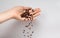 Female hand pouring roasted coffee beans. Woman palm pour coffee beans