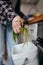 Female hand put organic food waste in a compost bin. The cook throwing peels in a bokashi container for decomposition.