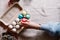 Female hand puts colorful easter egg in egg box