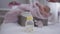 Female hand putting baby bottle with formula at front touching infant hand at background. Caring Caucasian mother taking