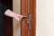 Female hand putting key card switch in to open hotel room door