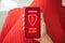 Female hand red dress holding phone warning virus alert alarm