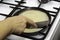 Female hand removes pancake from the pan with a metal spatula