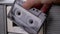 Female Hand Rotates Old Cassette 90s Near Gray Vintage Receiver. Close-Up. Zoom