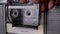 Female Hand Rotates Old Transparent Cassette, Inserts Into Tape Recorder. Zoom