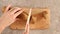 Female hand slices fresh rye baguette