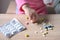 Female hand of a small child, baby, girl playing with medical pills, hazardous to health, drug poisoning concept, poor babysitting
