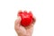 Female hand squeezes red heart isolated on white background. Close-up