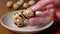 Female Hand Takes One Quail Egg from the Plate, Examines it in Hand. Close-up